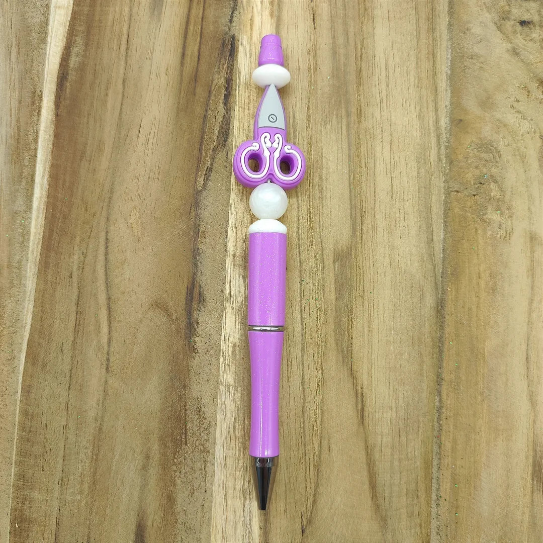 stylo violet ciseau