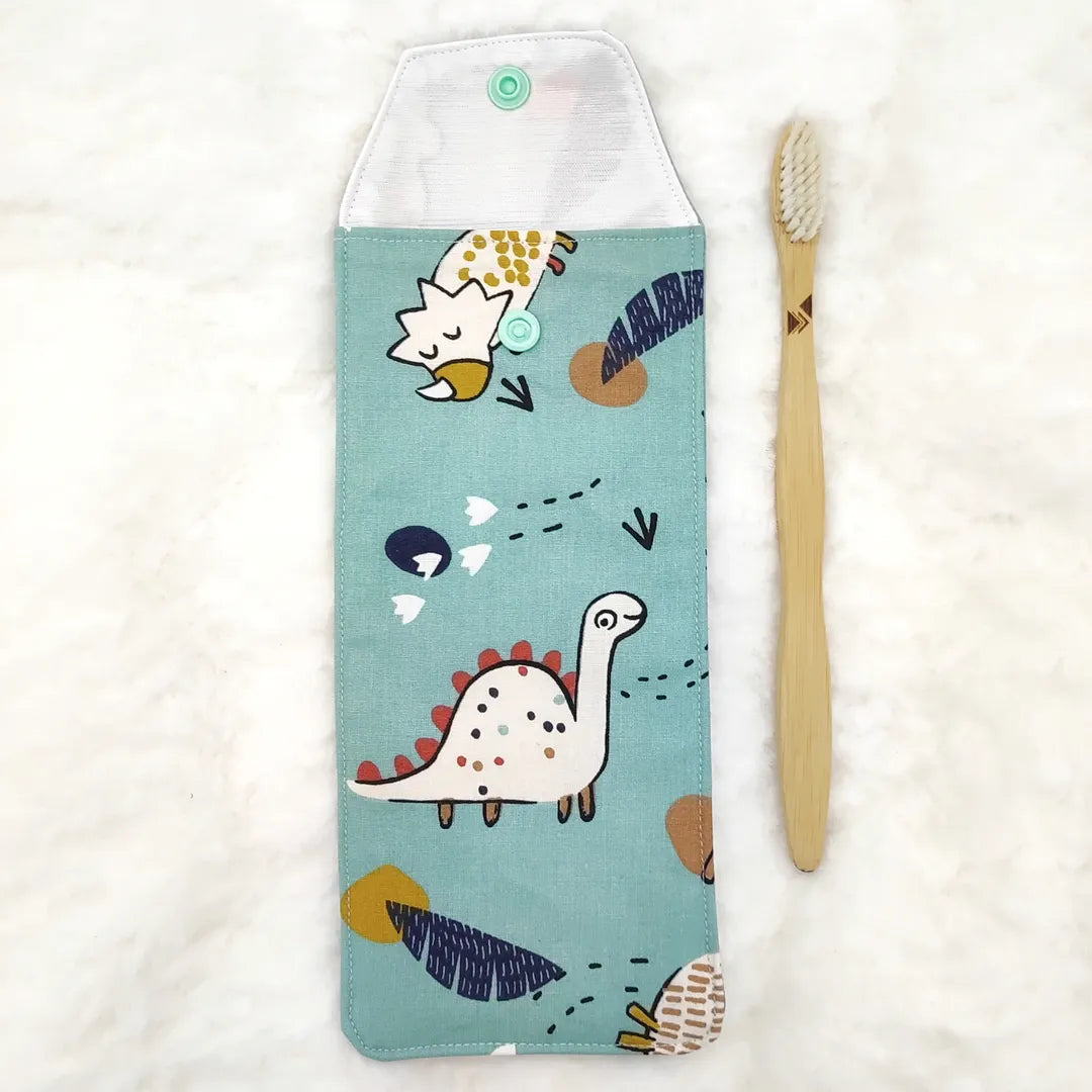 étui personnalisable pour enfant bleu motifs dino avec une brosse à dent