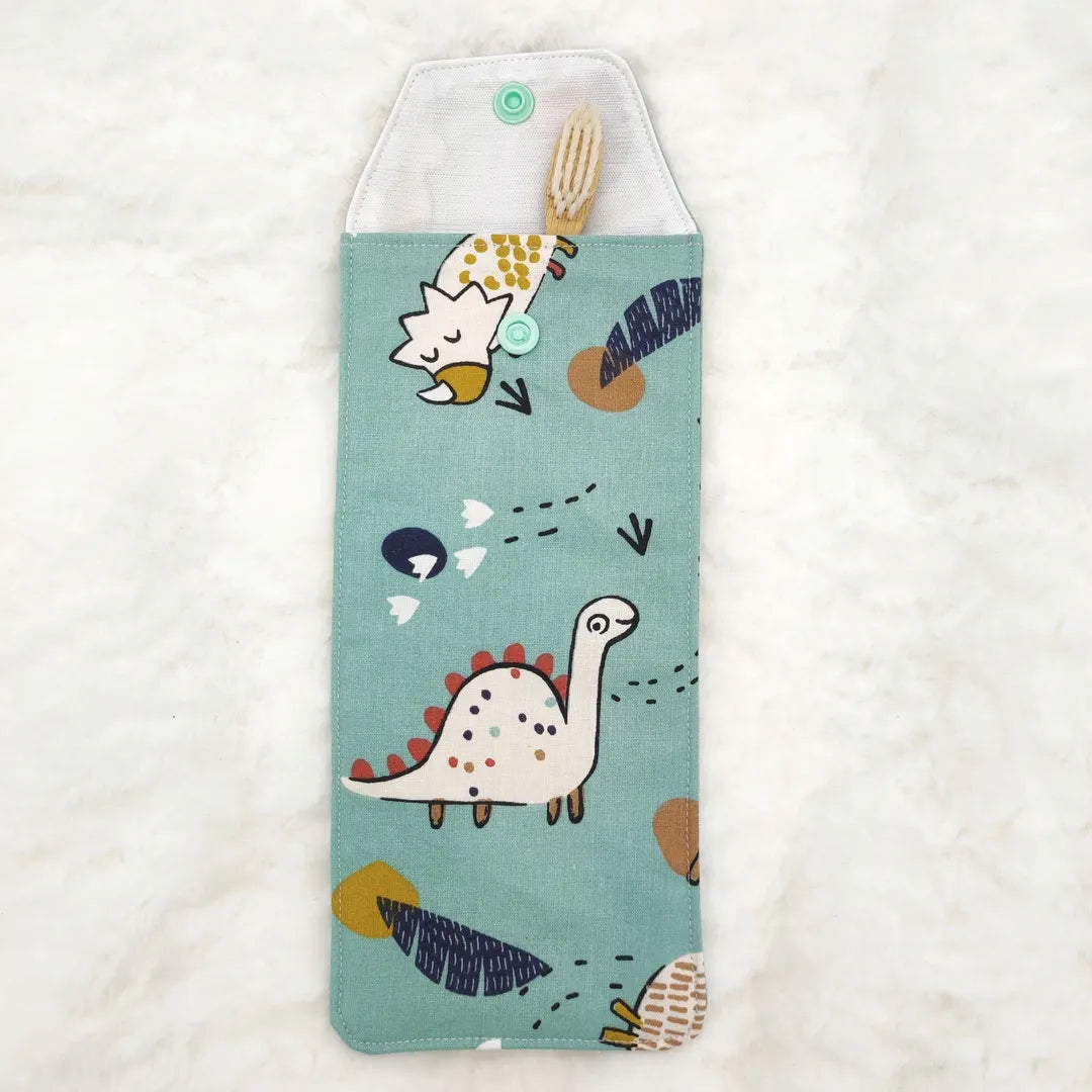 étui personnalisable pour enfant bleu motifs dino avec une brosse à dent